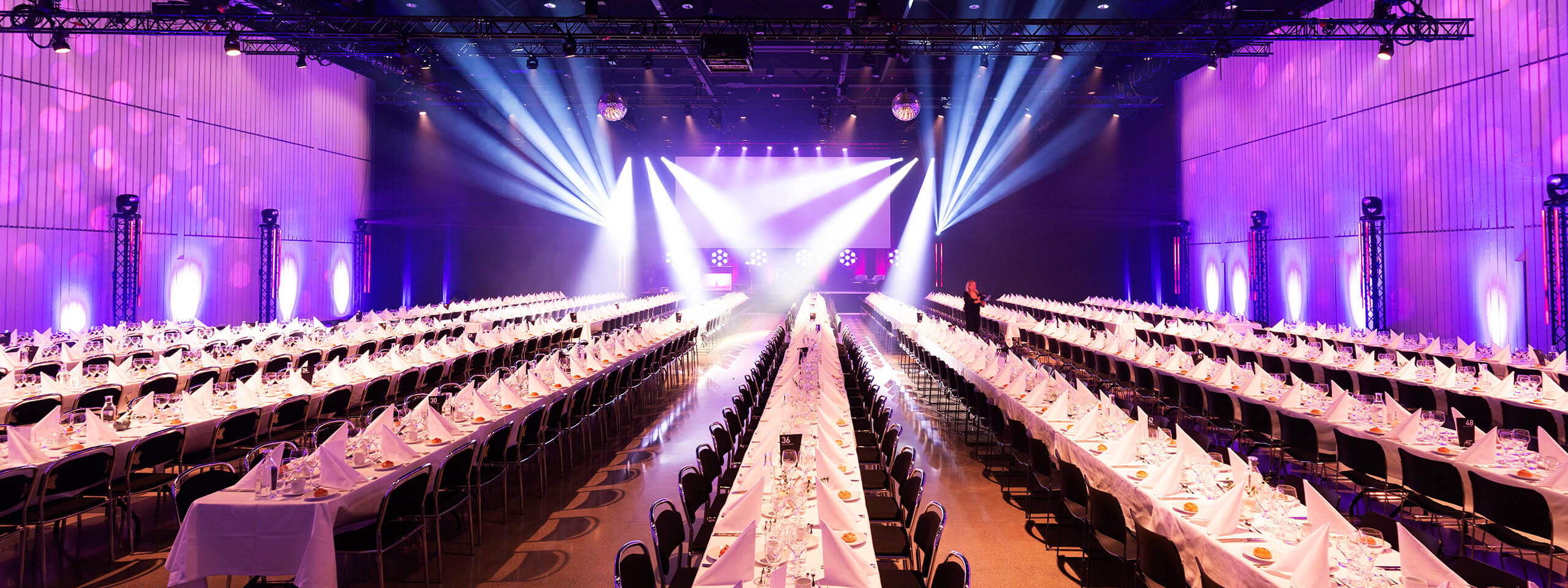 Set tables in front of a stage in the Artbox